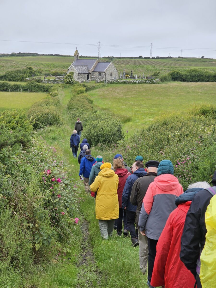 A group of AAS members walking to Llanbeulan church